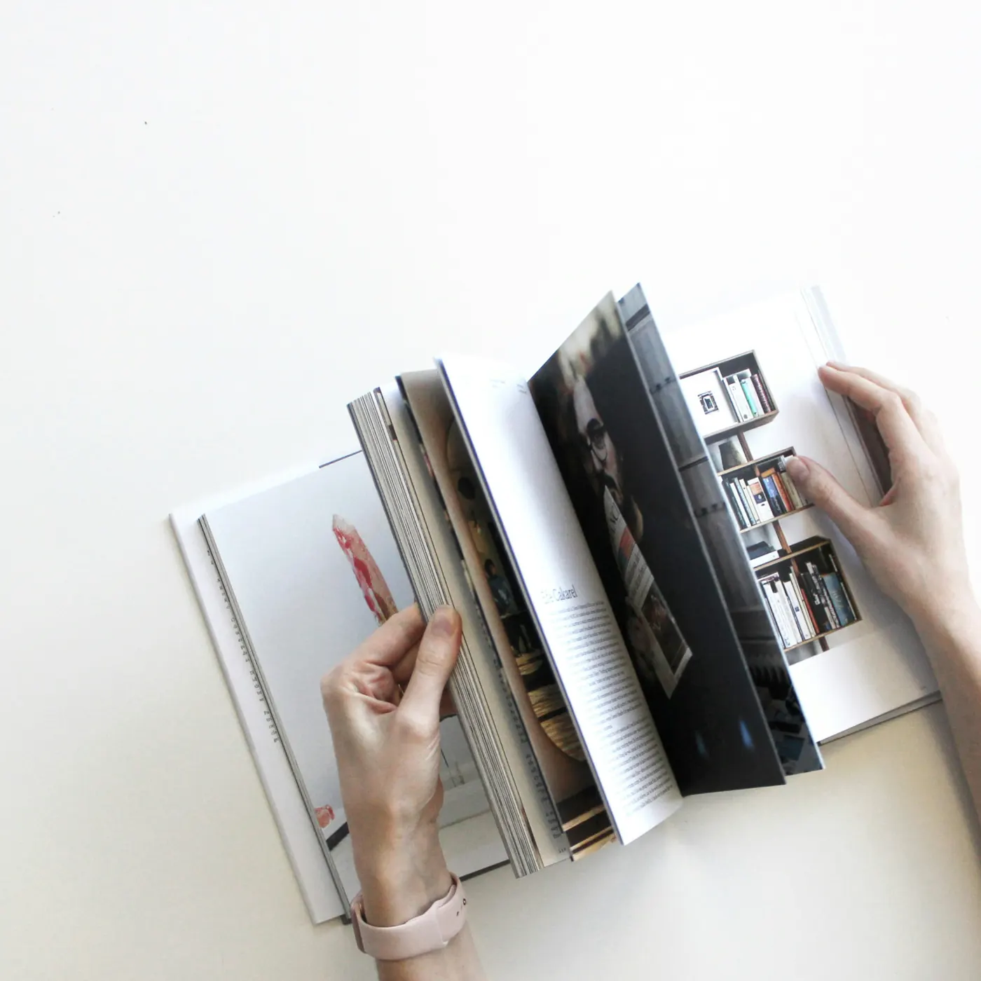 Someone flicking through the pages of a printed photo book