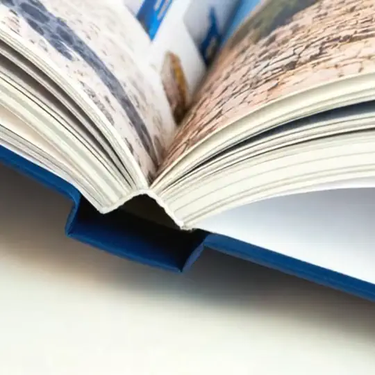 A close-up video of a hardcover photo book being opened